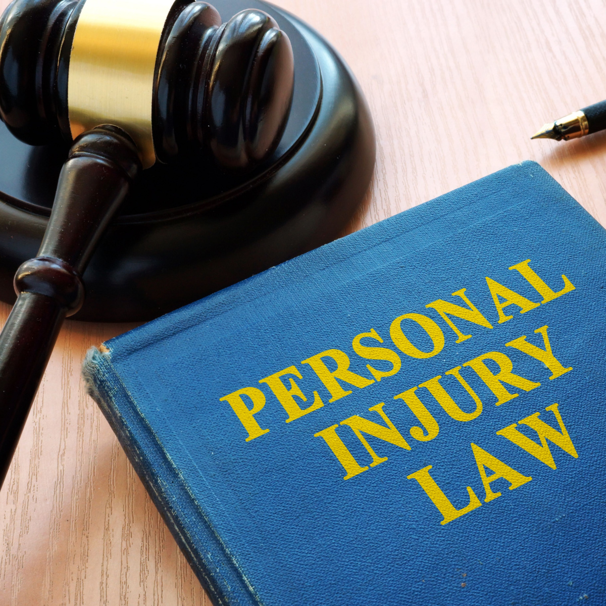 Houston personal injury law handbook on judge’s table with a gavel and pen.